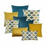 A collection of nine cushion covers in blue and gold colours and designs, featuring three blue cushions, three gold cushions and three cross pattern cushions.