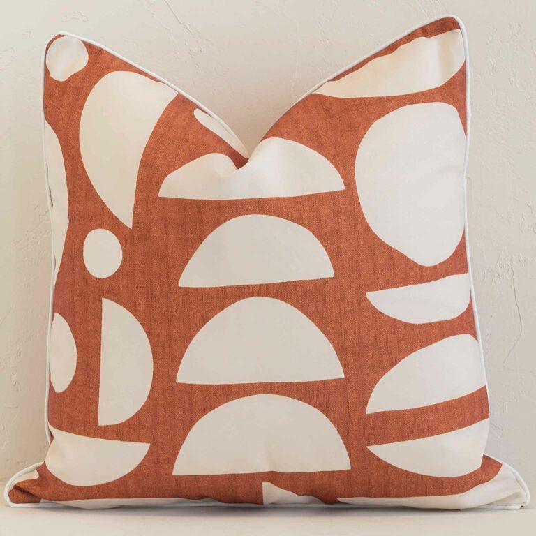 An eye-catching outdoor square cushion cover featuring a hue that is rust. It has a unique geometric style.