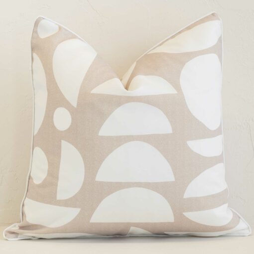 Sand geometric cushion cover sits against a white wall. It is constructed from a superior looking outdoor material and has square dimensions.