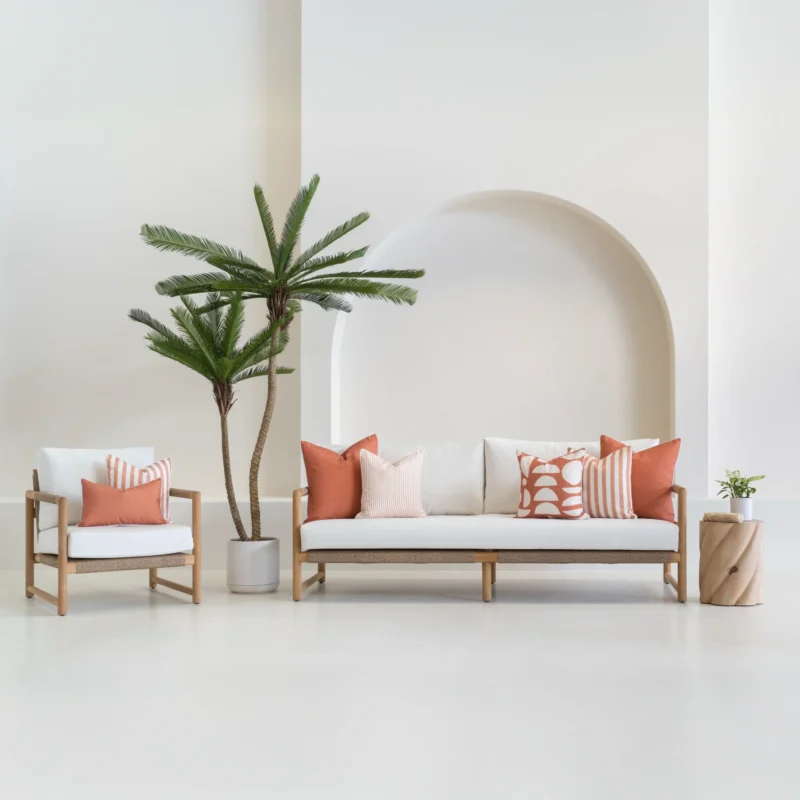 7 outdoor sofa cushions in a horizon rust colour shown on a white sofa.