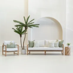 Outdoor seating with white sofa displaying a set of 7 horizon sage outdoor sofa cushions on it.