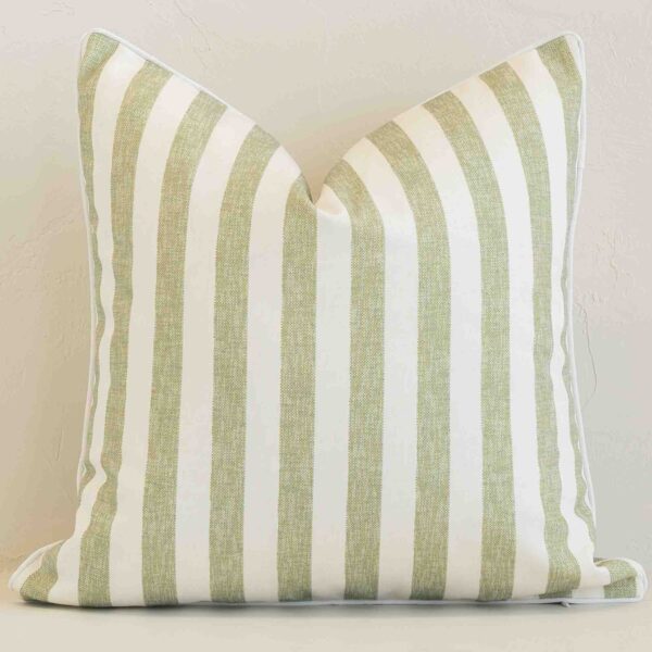 Sage outdoor cushion cover features prominently against a white wall. It is a square design and has a stripe decorative finish.