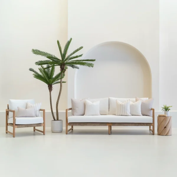 A set of 7 horizon sand outdoor sofa cushions sitting on a white sofa.