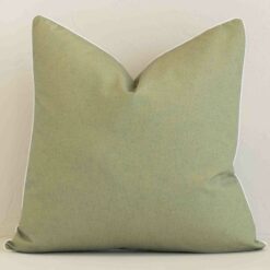 A hero shot of a solid-colour large cushion cover. It is made from a deluxe outdoor fabric and features a sage colour.