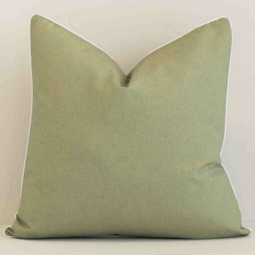 A hero shot of a solid-colour large cushion cover. It is made from a deluxe outdoor fabric and features a sage colour.