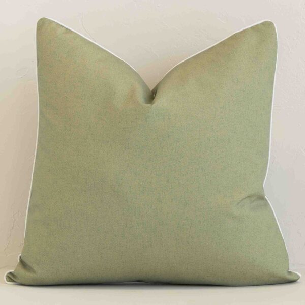 A hero shot of a solid-colour large cushion cover. It is made from a deluxe outdoor fabric and features a sage colour.