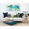 Olive and teal cushions and wall art in Ikat pattern against a white wall and sofa.