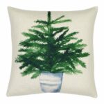 Photo of cute cotton linen cushion with potted green plant