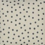 Photo of plain cotton linen bedroom cushion with grey polka dots