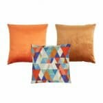 Photo of 3 square cushions in burnt orange and copper colours