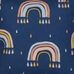 Cute navy kids cushion with pastel coloured rainbows and raindrops