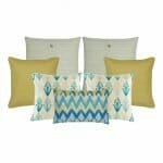 Two cushion covers in cable knit design, two gold cushion covers, two plant pattern cushion covers and one chevron pattern in rectangular shape.