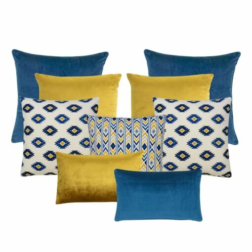 A collection of nine cushion covers in blue, gold and yellow colours featuring six plain cushions and three aztec pattern cushions.