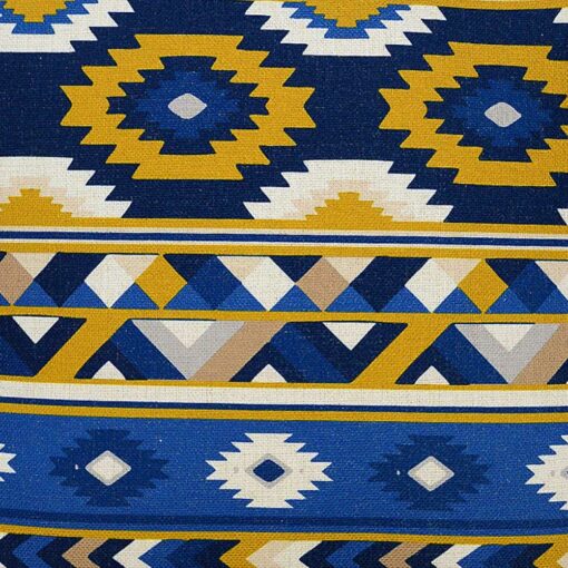 Close up image of Mexican tribal inspired cushion cover with white, blue and yellow colours