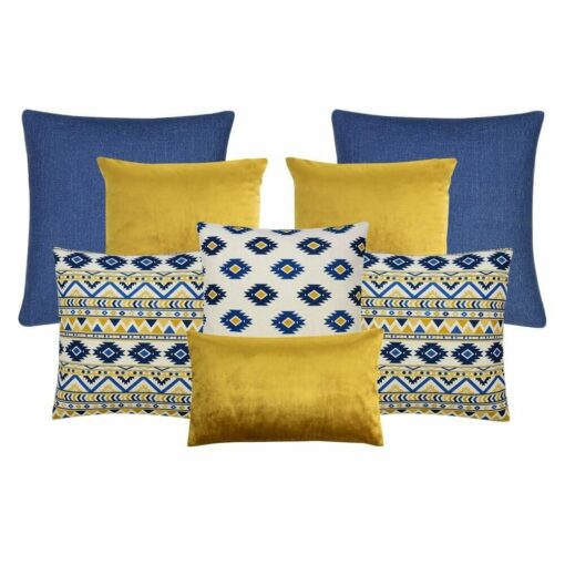 A collection of eight cushion covers with two blue cushions, three gold cushions and three blue and yellow cushion with an aztec design.