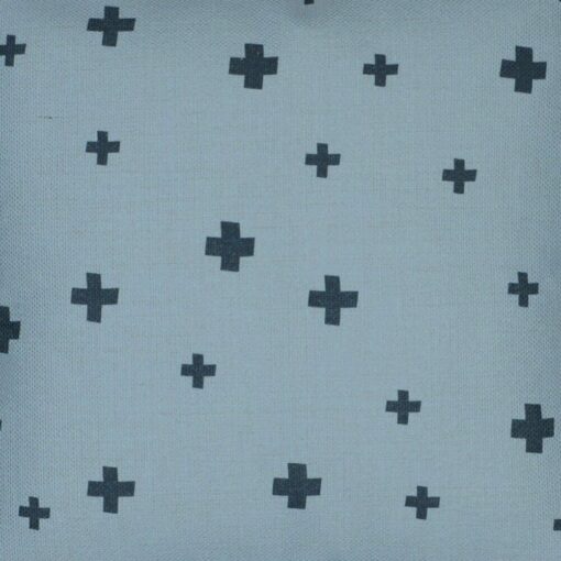 Close up image of blue kids cushion with cross pattern