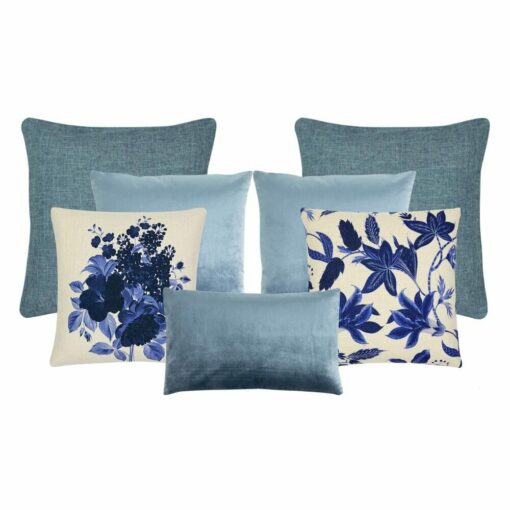 Striking collection of Hamptons style cushions with floral motifs in blue on muted grey and blue velvet and textured cushions