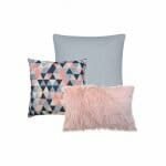 An image of one silver square cushion, a single pink faux fur cushion and a square cushion with a pink and blue triangle design.