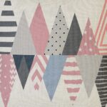 Close up image of white cushion cover with pink and grey triangles
