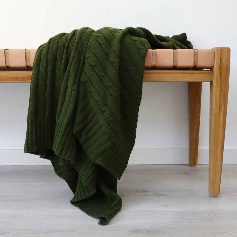 Olive Green Knitted Throw - 130x150cm - TH115 An image of a green knitted throw draped over a stooll