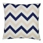 A bold geometric beige and navy print on a water resistant outdoor cushion cover.