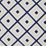 A close up of a bold geometric beige and navy print on a water resistant outdoor cushion cover.