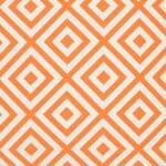 A close up of a bold geometric orange print on a water resistant outdoor cushion cover.