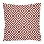 A bold geometric red print on a water resistant outdoor cushion cover.