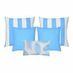 A set of five outdoor cushions in light blue colours and striped, plain and botanical designs.