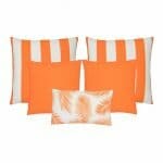 A set of five outdoor cushions in orange colours and striped, plain and botanical designs.