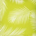 A close up of a lovely outdoor cushion with palm tree green print on a white background.