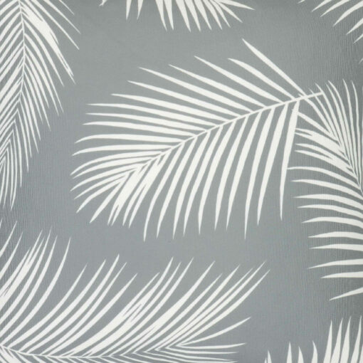 A close up of a water resistant grey outdoor cushion cover that has a beautiful palm tree leaf print.