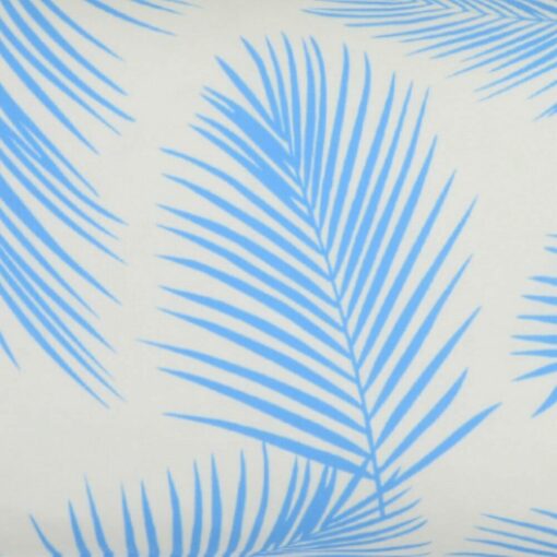 A close up of a lovely outdoor cushion with palm tree blue print on a white background.