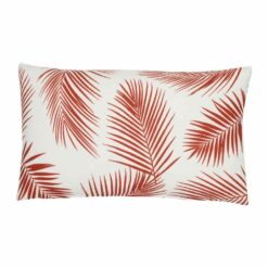 A lovely outdoor cushion with palm tree red print on a white background.