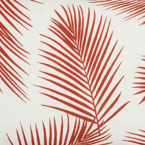 A close up view of a lovely outdoor cushion with palm tree red print on a white background.