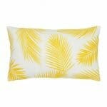 A lovely outdoor cushion with palm tree yellow print on a white background.
