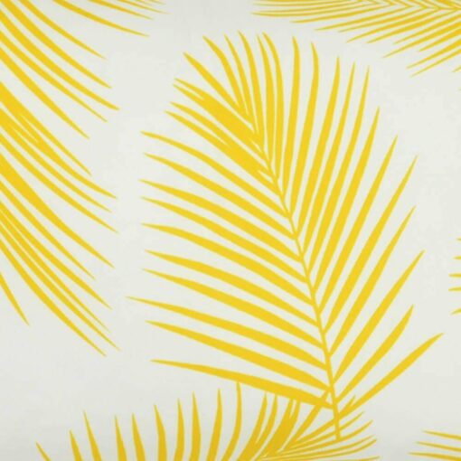 A close up view of a lovely outdoor cushion with palm tree yellow print on a white background.