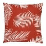 A water resistant red outdoor cushion cover that has a beautiful palm tree leaf print.