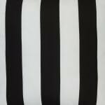 A close up view of an outdoor floor cushion that is black and white in colour and has stripes on one side and a plain colour on the other.