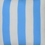 A close up view of an outdoor floor cushion that is blue in colour and has stripes on one side and a plain colour on the other.