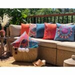 Colourful and bright outdoor cushions in neutral brown sofa