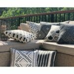 Tribal patterned black and white outdoor cushion covers in rattan lounge seat