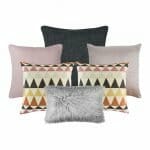 A collection of six cushion covers featuring one charcoal grey cushion, two pink cushions, two patterned cushions and one grey faux fur rectangular cushion cover.