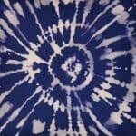 Close up of blue and white square cushion cover with tie-dye design