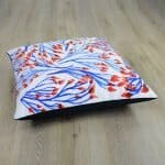Large white cushion with red and blue floral design