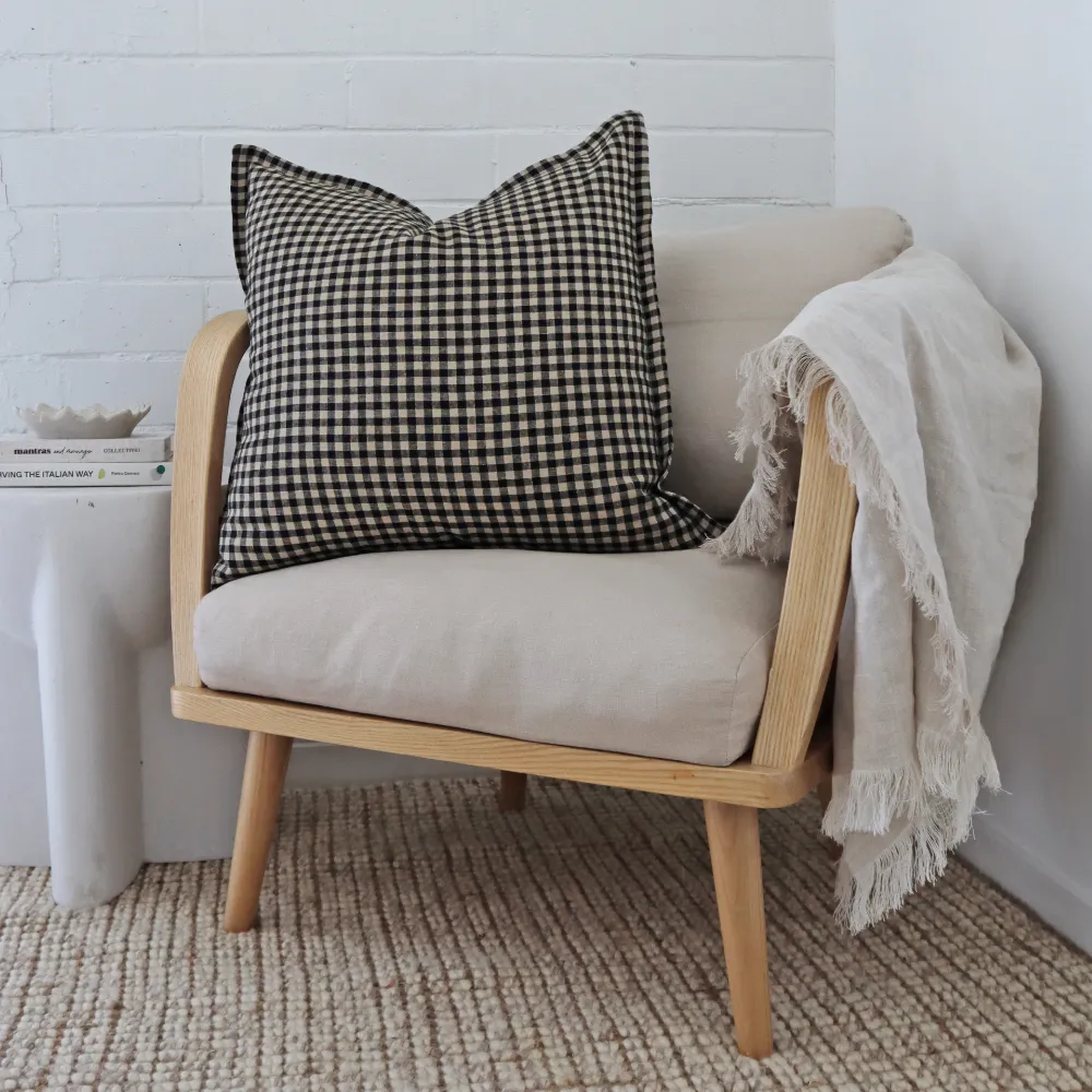 A 55x55 cushion cover rests on a single armchair.