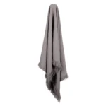 A premium grey linen throw drapes from a hook.