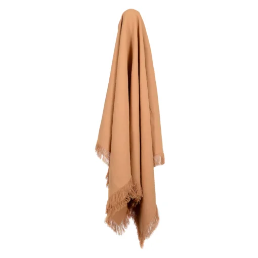 A mustard linen throw hangs on a hook.