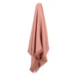 A lovely pink coloured linen throw drapes from a hook.