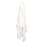 A soft white linen throw hangs on a hook.